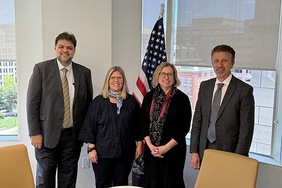 LSI Director Rabieh Razzouk, IREX Chief Impact Officer Rebecca Bell Meszaros, LSI Associate Director Stephanie Simmons Zuilkowski and IREX President and CEO Aleksander Dardeli pose for a photo following a partnership signing ceremony in Washington, D.C.